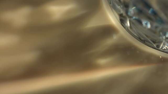 Blurred defocused background with crystal reflections create golden and blue highlights with soft bokeh. Concept luxury, design, branding, celebration, wallpaper, advertising, and abstract art.