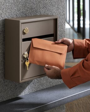 Supervisor Checking Locked Drop Box with Envelope Pouch in Campus Hallway