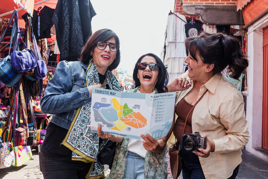 senior latinas friends women travellers in tourist market in Mexico Latin America, hispanic middle age females shopping in vacations 