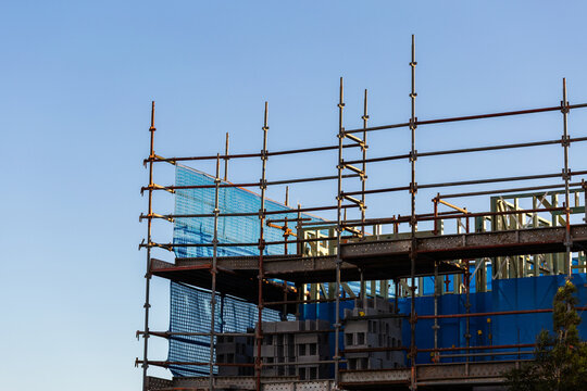 multi storey commercial worksite with scaffolding rising up around building under construction