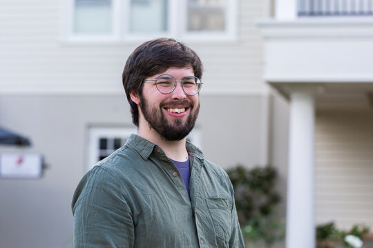 portrait of smiling twentysomething man wearing glasses