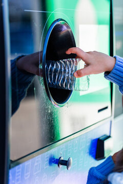 child returning plastic bottle for recycling at return and earn collection point in Australia