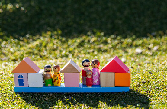 Housing affordability and family concept shown with coloured homes made of blocks