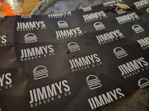 A Jimmy's Burger & Co branded paper covered in a repeating burger logo pattern on November 2, 2024 in Cairns, Australia.
