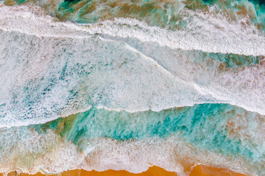 Sand and water mix to form a colourful abstract at Maroubra Beach