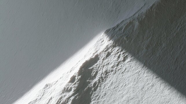 Close-up of a snow-covered mountain peak. the peak appears to be steep and jagged, with a jagged edge on the right side. the snow is a light grey color and has a rough texture.