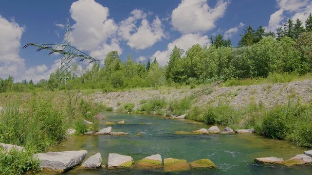 Artificial fish ladder flowing through a natural river landscape with a high-voltage transmission tower in background, illustrating renewable energy infrastructure and aquatic ecosystem restoration