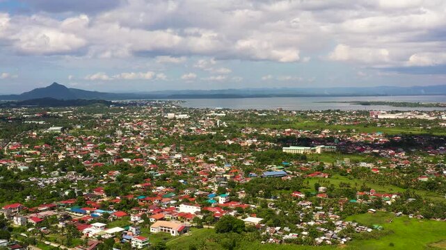 Tacloban city, Leyte island, Philippines. Tropical landscape with panorama of the town, view from above. Town and sky with cumulus clouds. Summer and travel vacation concept.