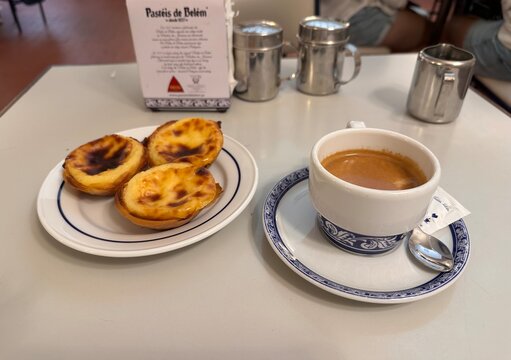 Three original Past&eacute;is de Bel&eacute;m custard tarts and coffee at the historic caf&eacute;, 2 April 2026, Lisbon, Portugal