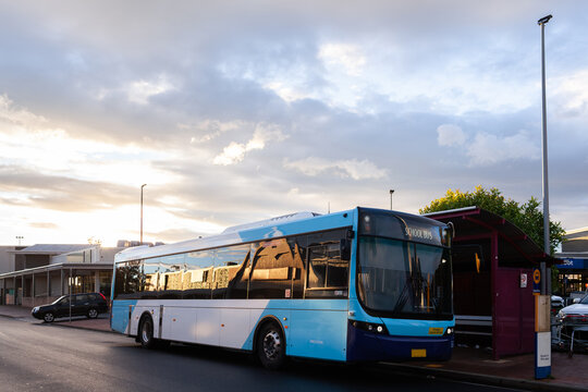 Singleton streetview of public transport bus parked at bus stop near the shops