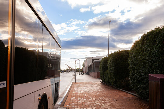 Singleton streetview of public transport bus parked at bus stop near the shops