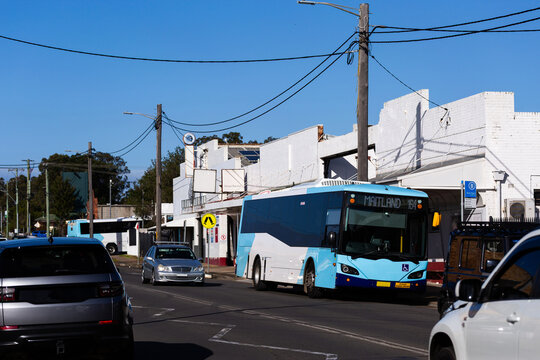 Bus stopped at bus stop along road in Cessnock