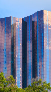 Close up view of a tall skyscraper with colourful windows