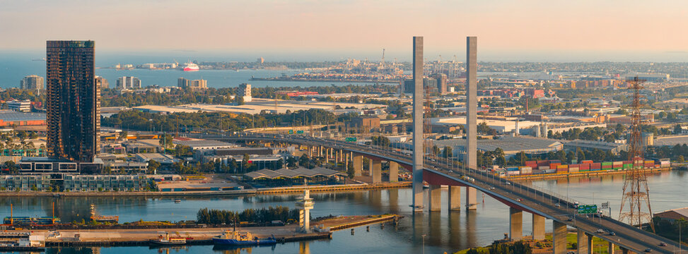 Aerial panorama view of tall pylons on a bridge crossing an inner city river