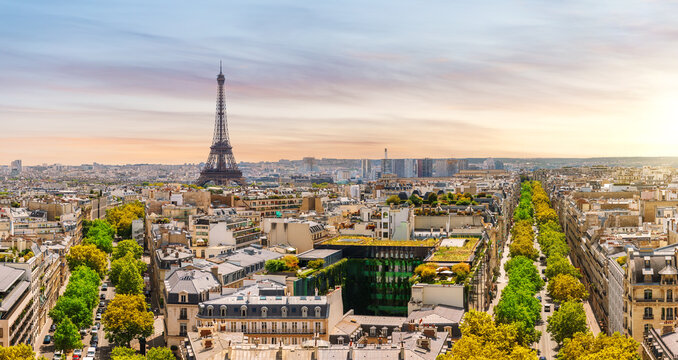 Romantic Paris sunset panorama with famous Eiffel Tower and historic roofs