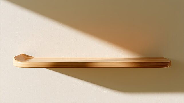 Simple light wood shelf with soft shadows cast on a neutral wall