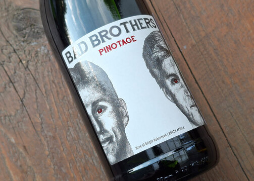 Bad Brothers Pinotage Red Wine Bottle With Illustrated Label From South Africa On Wood Surface