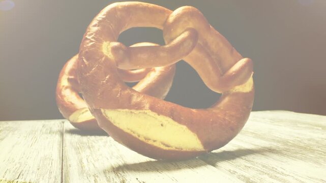 Traditional Bavarian Pretzel Motion Background with Rustic Wooden Table and Warm Golden Light Perfect for Oktoberfest Food Festival Menu and Brewery Promotion