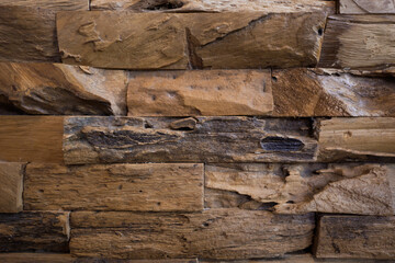 Fototapeta premium Detailed close-up of rough reclaimed wooden wall tiles, showcasing natural organic textures and weathered grain.