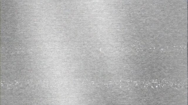 Abstract metallic texture background with subtle light reflections and noise.