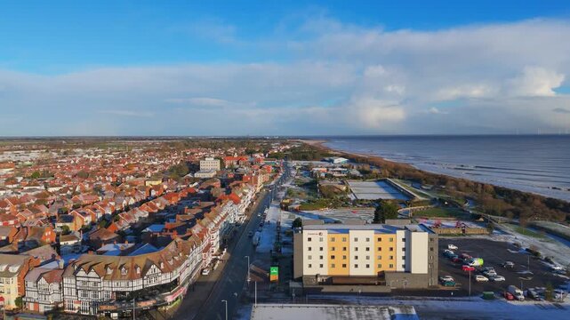 Drone shot reveals a coastal town with red rooftops. rural landscape, Wainfleet, Village, Skegness in morning sunrise wintertime.
