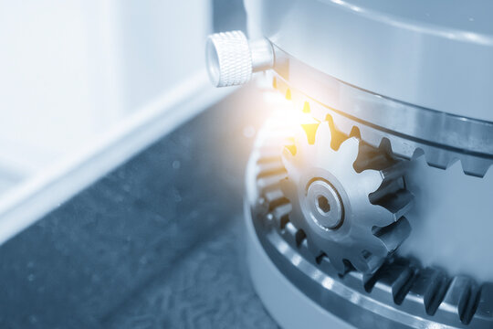 Close-up of a reverse direction gear set in a blue tone scene with dramatic lighting effects.