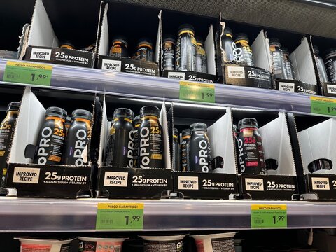 Rows of Danone Alpro YoPRO high-protein yogurt drinks arranged in cardboard trays on a refrigerated supermarket shelf with Portuguese &euro;1.99 promotional price labels, 2 April 2026, Lissabon, Portugal