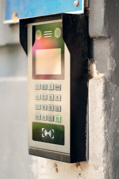 Modern outdoor smart intercom access panel with video camera, PIN keypad, and RFID contactless reader mounted at building entrance.