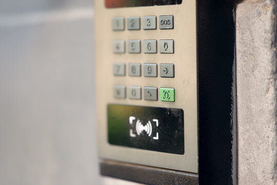 Modern outdoor smart intercom access panel with video camera, PIN keypad, and RFID contactless reader mounted at building entrance.