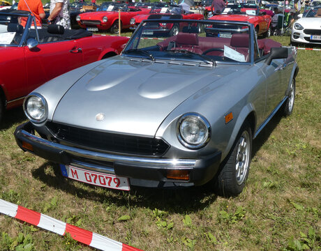 Garching near Munich, Germany - Old Timers Show: vintage silver Fiat 124 spider of 1981 frontal view