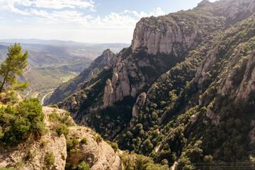 Fototapeta premium Peaks of Montserrat mountains in a rays of a sun at sunset.