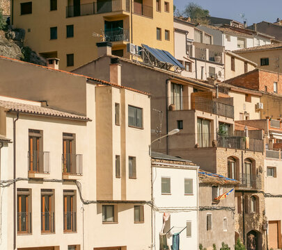 Beautiful old village with cozy houses on a hill among rocky mountains.