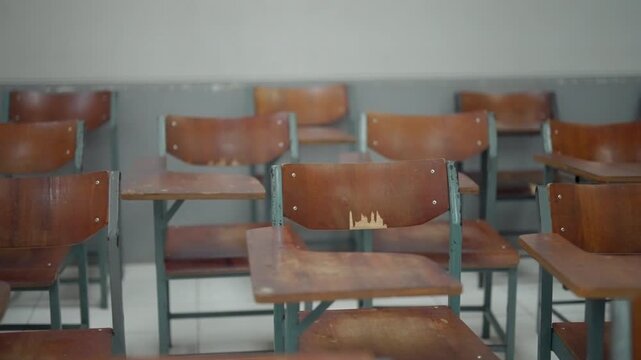 Empty classroom with neatly arranged wooden student desks and chairs, creating a quiet learning environment. Ideal for education, school, academic, teaching, back-to-school, classroom management, and 