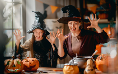 Obraz premium Happy Family Halloween Celebration with Costumes and Pumpkins