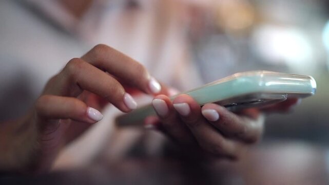 Close-up of a woman interacting with a smartphone for online communication, mobile banking, digital business, and social networking. Suitable for fintech, remote work, e-commerce, and smart technology