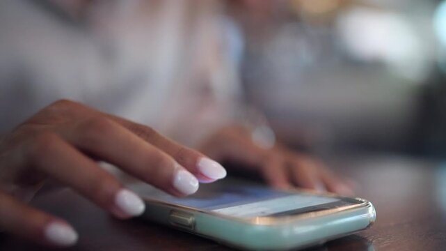 Close-up of female hands using a smartphone for messaging, mobile applications, online services, and digital communication. Perfect for technology, social media, business, remote work, and modern conn