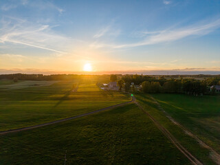 Aerial drone view of a rural lake and farmland landscape in Barkoczyn, Pomeranian Poland, captured in soft daylight. © Lukasz