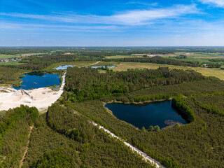 Beautiful aerial panorama of forests, lakes, and farmland near Barkoczyn, Poland, highlighting the rich natural scenery of the Pomeranian countryside. © Lukasz