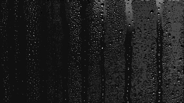 Water droplets on dark glass create a textured monochrome pattern with varying sizes and streaks condensation raindrops