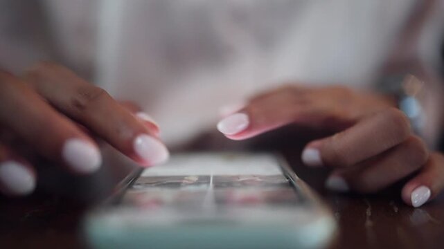 Close-up of a woman using a smartphone for mobile banking, online communication, and digital services. Ideal for fintech, cashless payments, social networking, online shopping, remote work, and modern