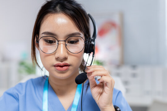 Professional women wearing headset providing telehealth support in clinic, representing virtual consultation, patient communication, healthcare service, remote care, medical assistance.
