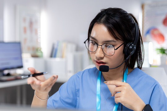 Professional women wearing headset providing telehealth support in clinic, representing virtual consultation, patient communication, healthcare service, remote care, medical assistance.