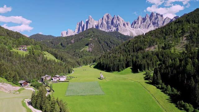 Mountains of the Dolomites in Italy with church by drone
