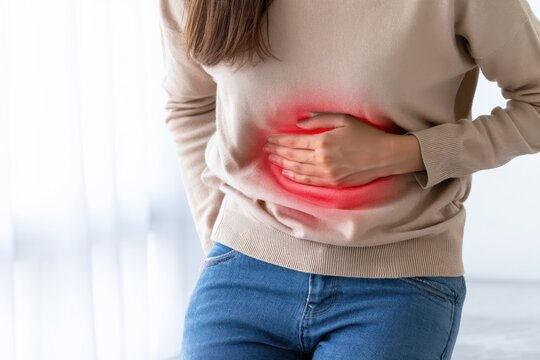 Stomach pain. Young woman touches her abdomen to acute pelvis pain. Glowing red light sign painful cramp, menstrual cycle distress ache or digestive spasm. Bladder infection symptom. Belly discomfort