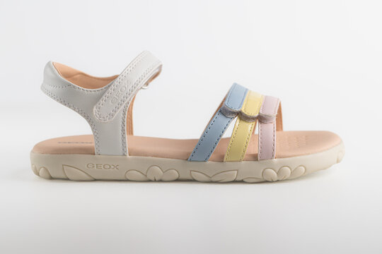 Lviv, Ukraine - July 26, 2026: light summer sandal for girls with pastel multicolored straps on light background