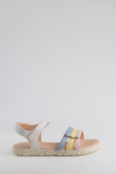Lviv, Ukraine - July 26, 2026: light summer sandal for girls with pastel multicolored straps on light background