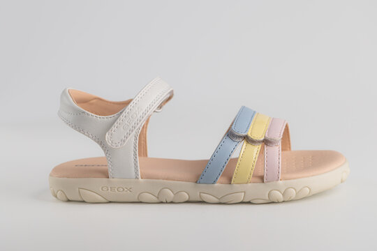 Lviv, Ukraine - July 26, 2026: light summer sandal for girls with pastel multicolored straps on light background