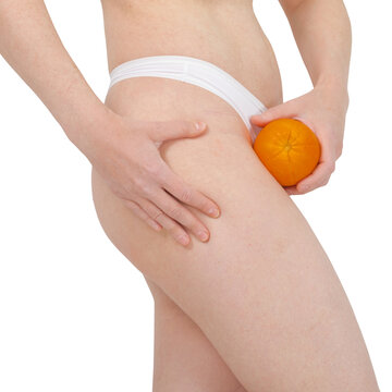 Woman holding orange against thigh to illustrate cellulite. Body positivity and skin health awareness. Concept of natural beauty, body acceptance and skincare routine for smooth skin