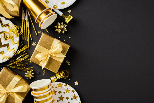 Golden party decor and present box left border black background