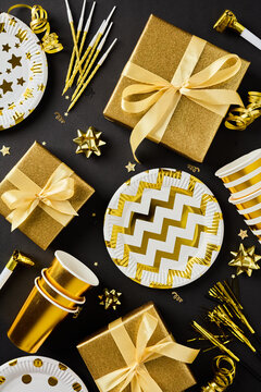 Golden party decor and gift box pattern vertical black background